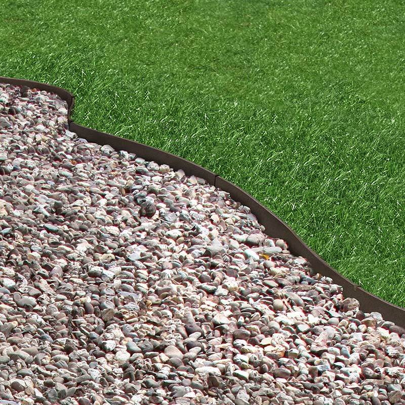 Core Edge Flexible Steel Lawn Edging show in Brown edging dividing grass from gravel path - Henderson Garden Supply