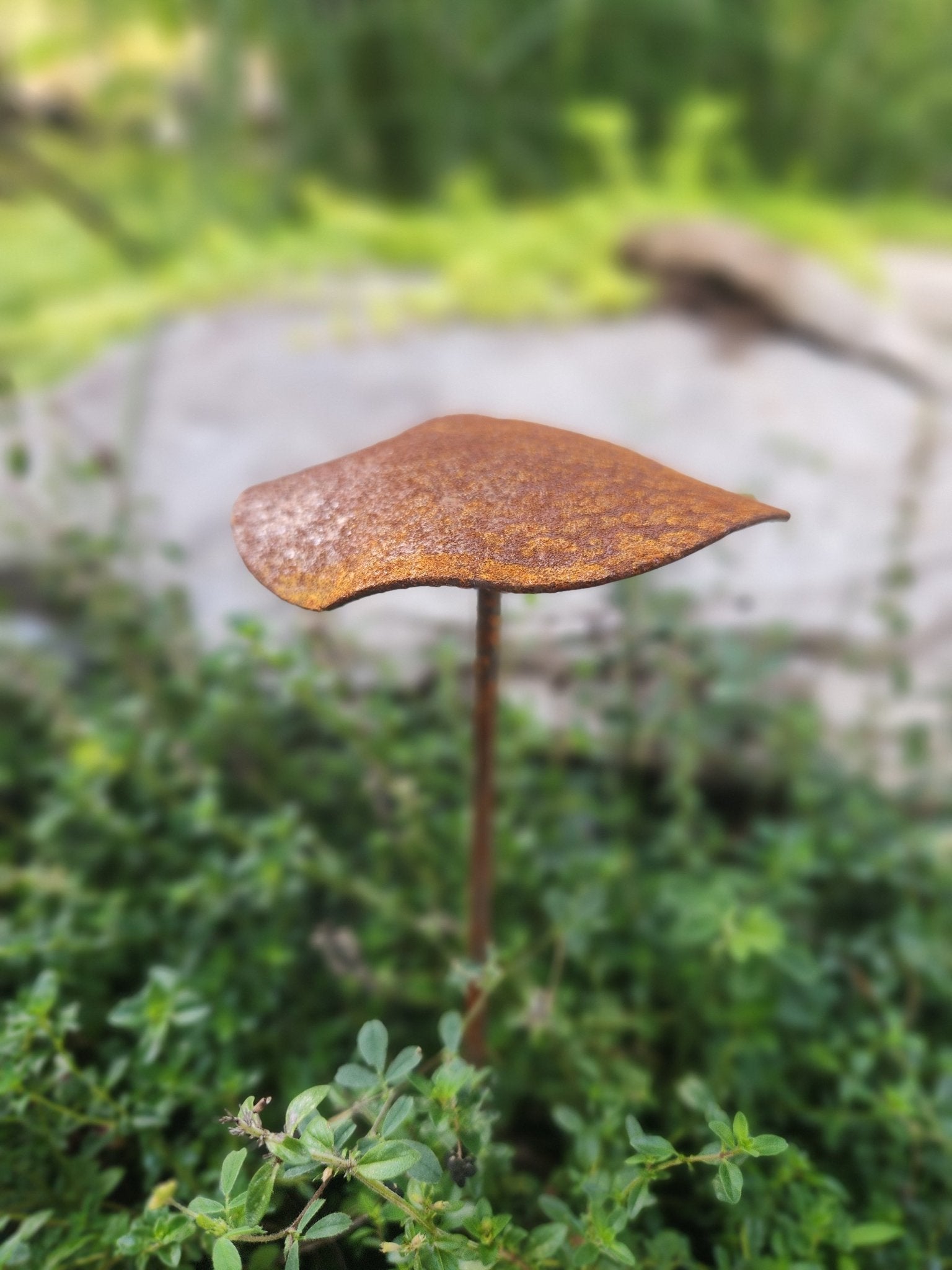 Decorative metal leaf sculpture in a garden setting - Henderson Garden Supply