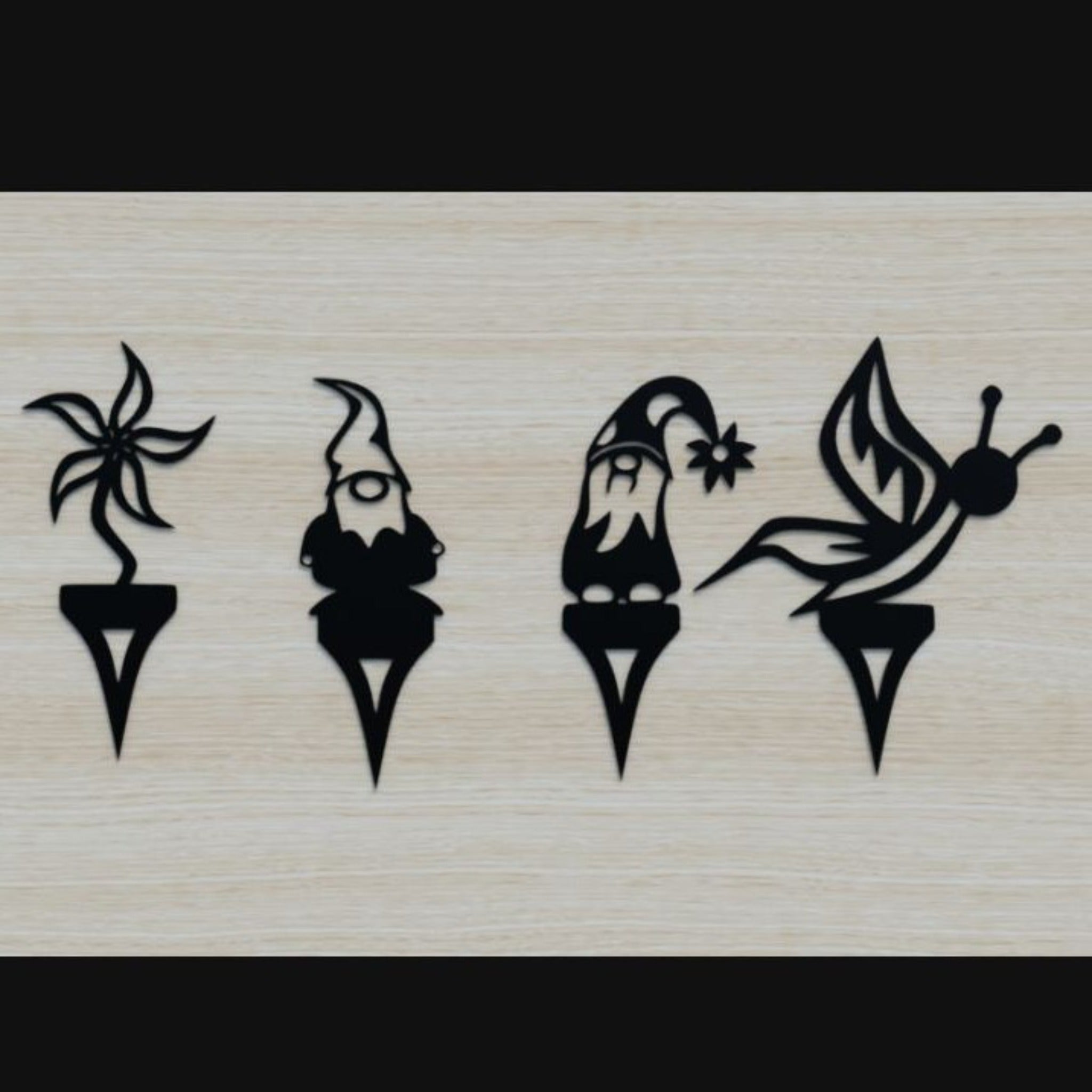 Set of four black silhouette stamps on a wooden background.  Henderson Garden Supply