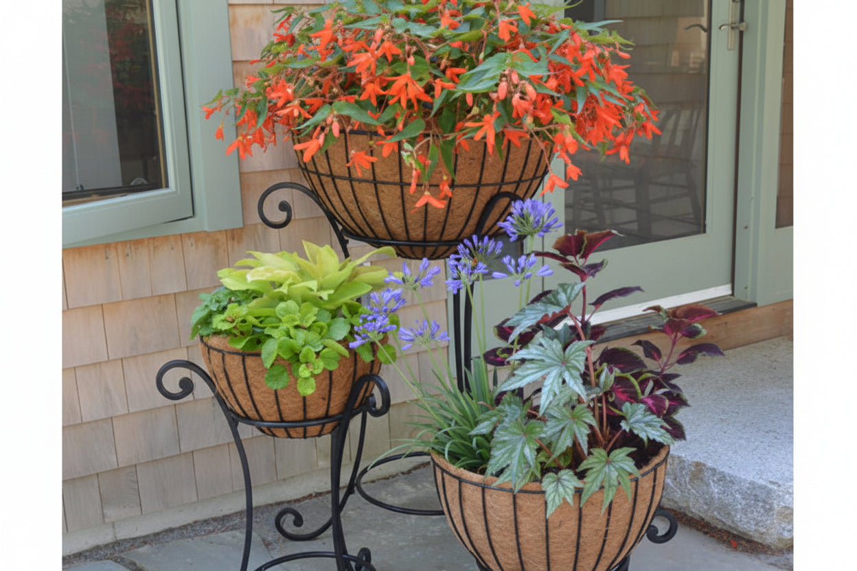 Decorative plant stand with three woven planters containing various plants on a patio.  Henderson Garden Supply