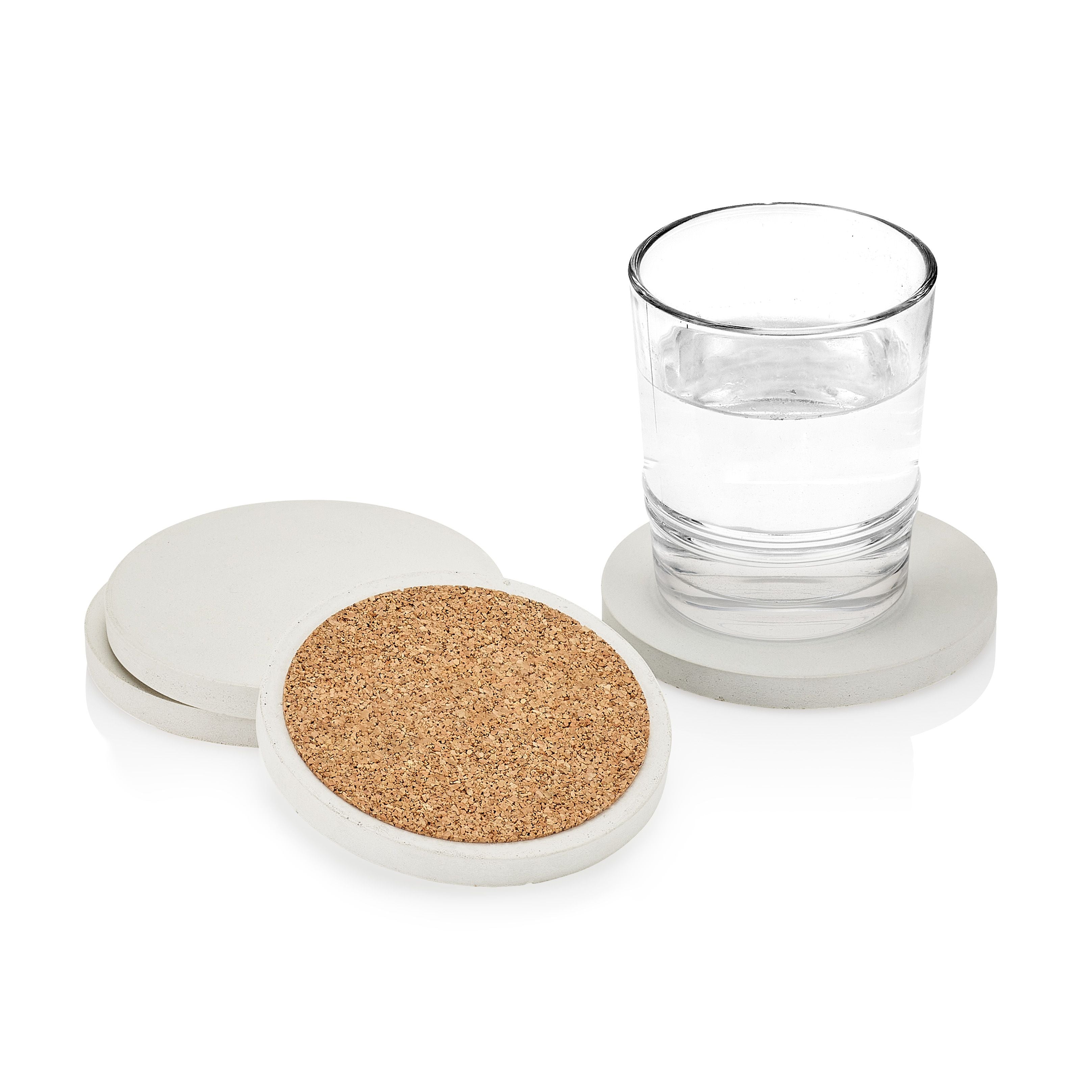 Set of coasters with cork bottom and white rim, one coaster with a glass of water on a white background.  Henderson Garden Supply