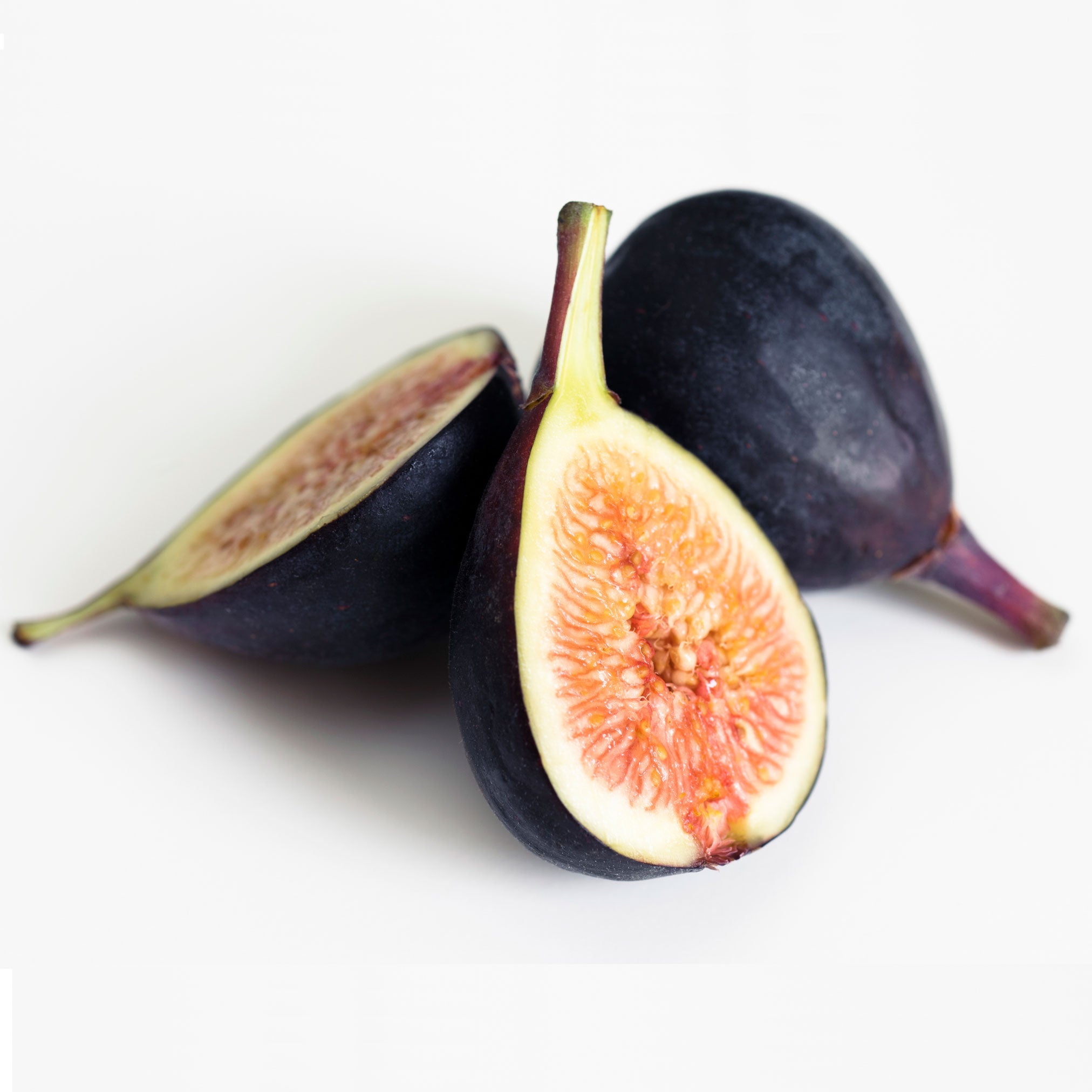 Two figs, one whole and one sliced open, on a white background.  Henderson Garden Supply