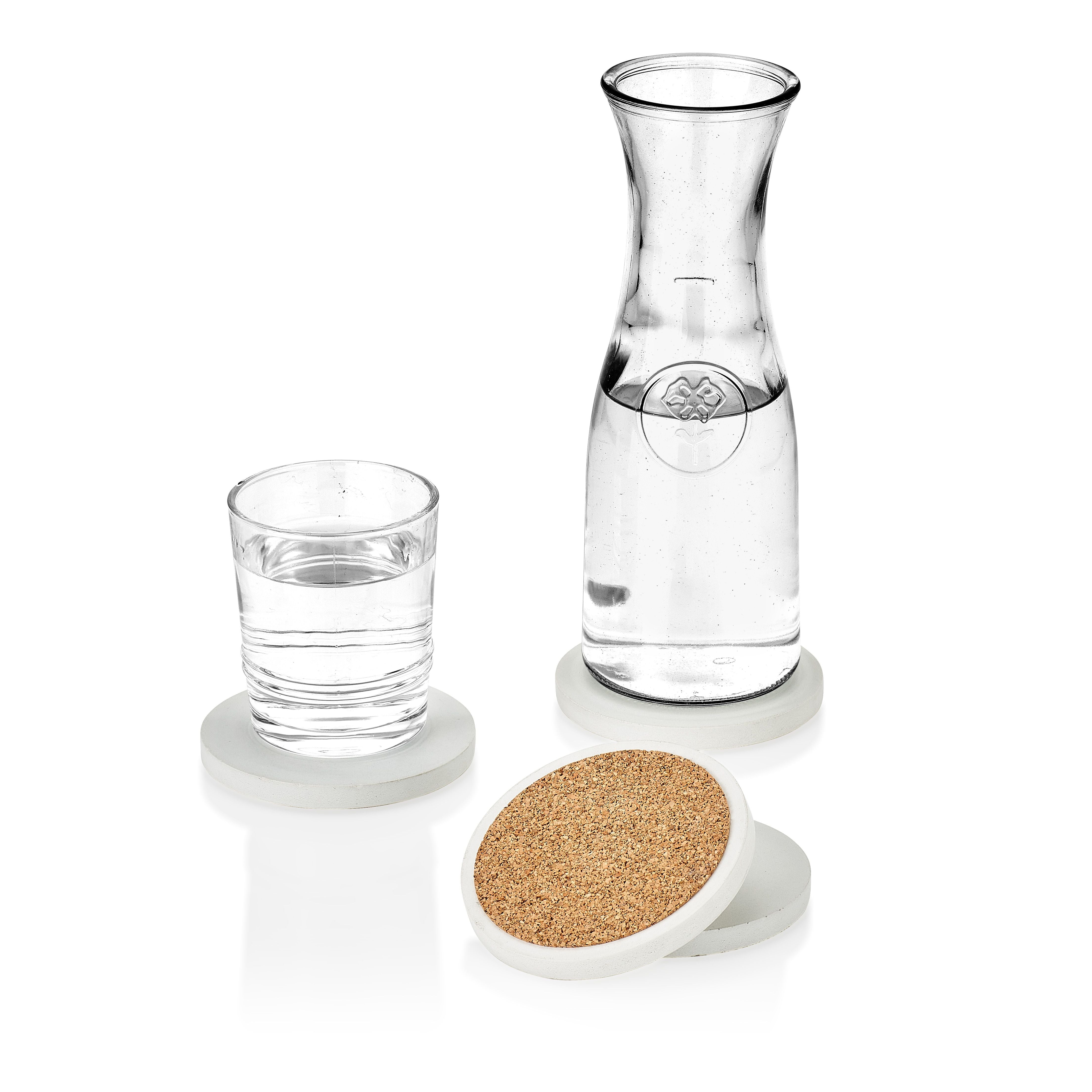 Clear glass carafe and glass with cork coaster on a white background.  Henderson Garden Supply